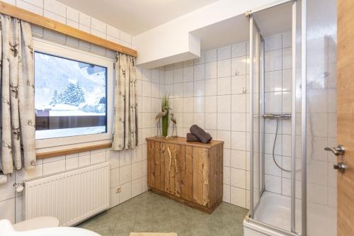 a bathroom with a shower and a window at Neuhof Appartements in Maishofen