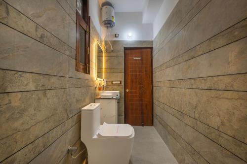 a bathroom with a toilet and a sink at Kasauli Hills Hotel in Kasauli