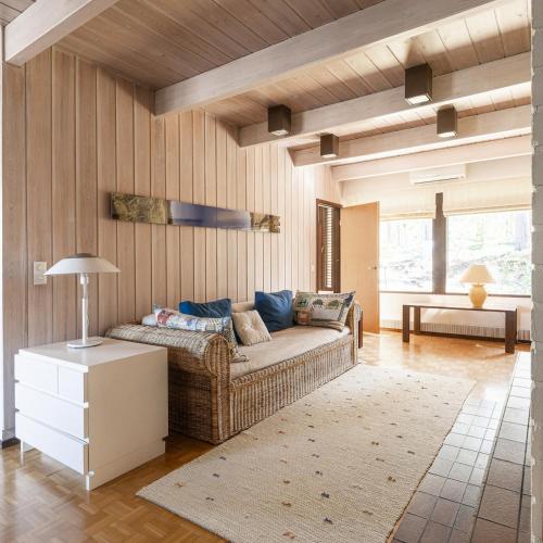a living room with a couch and a table at Villa Pulla - House Near Nature & City Center in Rovaniemi
