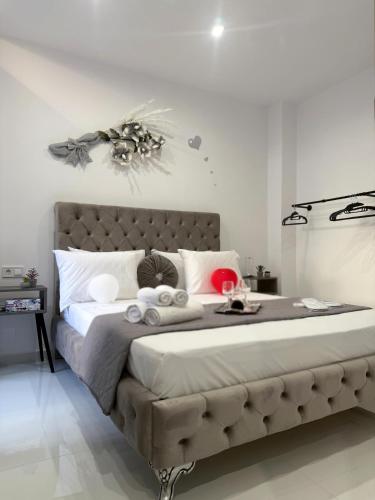 a bedroom with a large bed with white pillows at Villa Irene in Heraklio