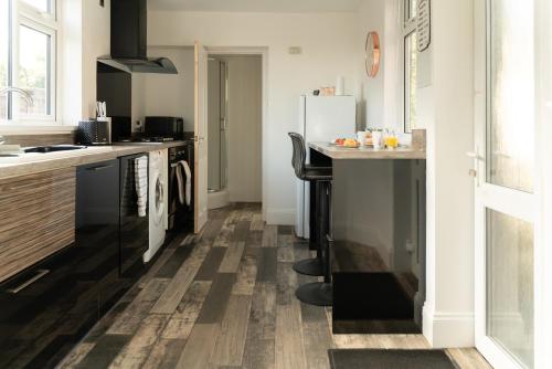 a kitchen with wooden flooring and a counter top at Spacious and Comfortable - 5 Bedroom Home in Kettering