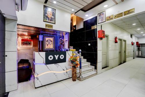 a lobby of a building with a sign on the wall at Hotel O ANANT ONE HOTEL AND BANQUETS in Ghaziabad