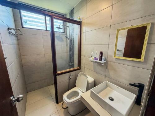a bathroom with a sink and a toilet and a mirror at Jebat D'Manggis Janda Baik - Mountain View in Bentong