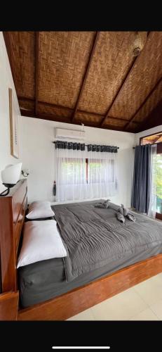 a bedroom with two beds and a window at Green Corner VILLA in Bukit Lawang