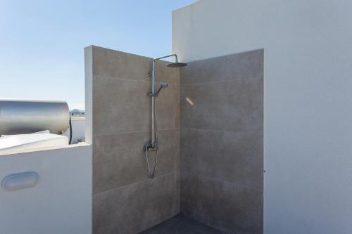 a shower with a glass door in a bathroom at BlueBell Limassol Suites in Limassol