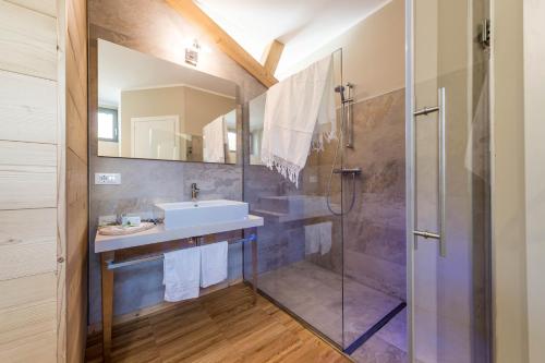 a bathroom with a sink and a shower at Agritur La Dolce Mela - Adults Only in Vezzano