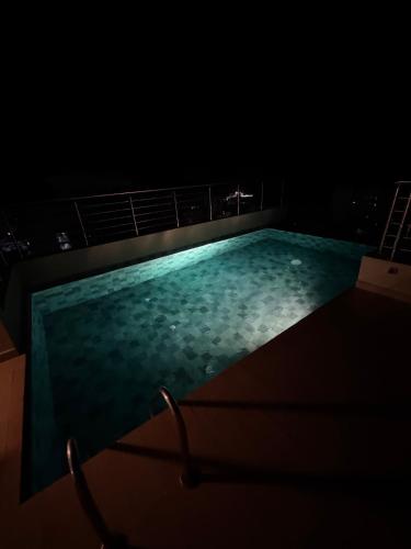 a swimming pool on top of a building at night at dwane in Dakar