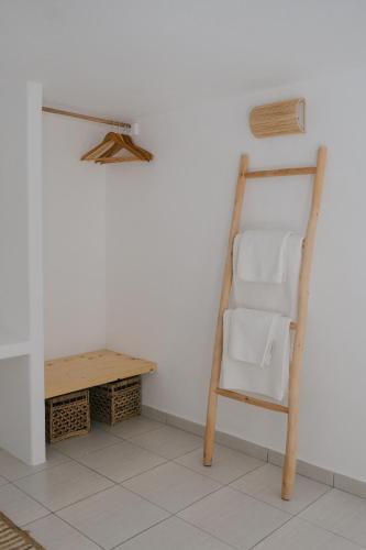 a towel ladder in a room with a table at Nissos Suites in Apollonia