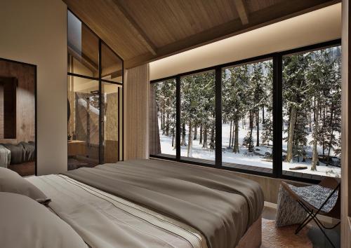 a bedroom with a large bed and a large window at Mountain Retreat by Dukley in Kolašin