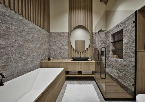 a bathroom with a tub and a sink and a mirror at Mountain Retreat by Dukley in Kolašin
