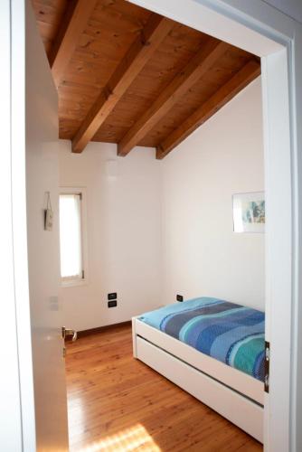 a bedroom with a bed and a wooden ceiling at A casa di Giò in Vittorio Veneto