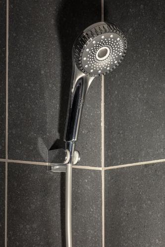 a shower with a shower head in a bathroom at Shiki - Hakone- in Hakone