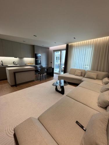 a living room with three beds and a kitchen at Skyline Exclusive 2 in Peje