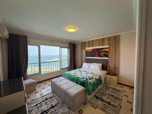 a bedroom with a bed and a view of the ocean at Gleem Sea View 8 in Alexandria