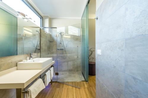 a bathroom with a sink and a shower at Agritur La Dolce Mela - Adults Only in Vezzano