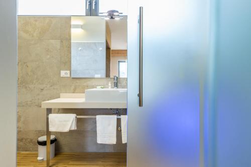a bathroom with a sink and a mirror at Agritur La Dolce Mela - Adults Only in Vezzano