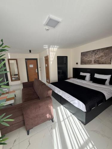 a bedroom with a large bed and a couch at La Vista in Gaziemir
