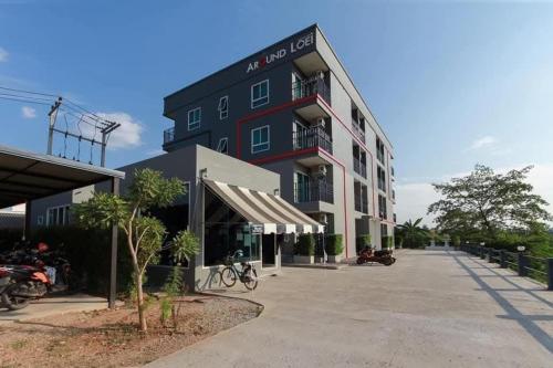 a large black building with motorcycles parked outside of it at Around Loei in Loei