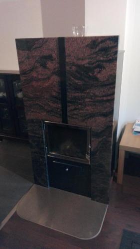 a stone fireplace with a tv in a room at Apartment Villa Ylläs 201 in Ylläsjärvi