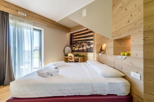 a bedroom with a large bed with two pillows at Agritur La Dolce Mela - Adults Only in Vezzano