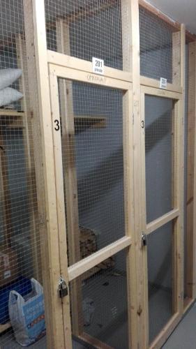 a wooden cage with glass doors in a room at Apartment Villa Ylläs 201 in Ylläsjärvi