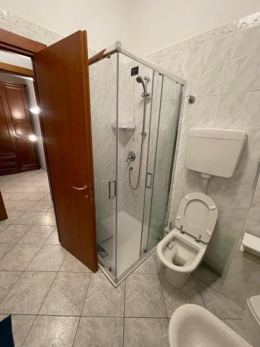 a bathroom with a toilet and a glass shower at La Vanitas in Cremona
