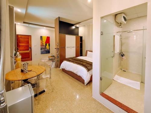 a bedroom with a bed and a bathroom with a shower at The View Boutique Hotel in Vung Tau