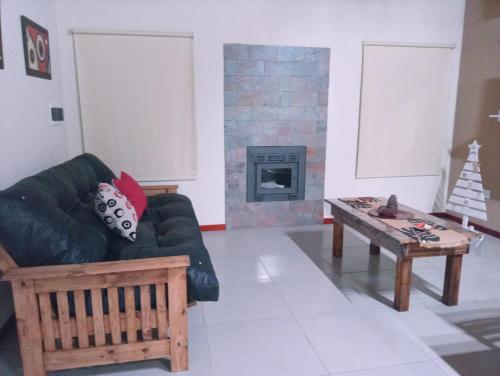a living room with a couch and a fireplace at Pinares del Norte in Federación