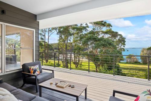 a living room with a view of the ocean at Mherringa at Bawley - enjoy panoramic ocean views in Bawley Point