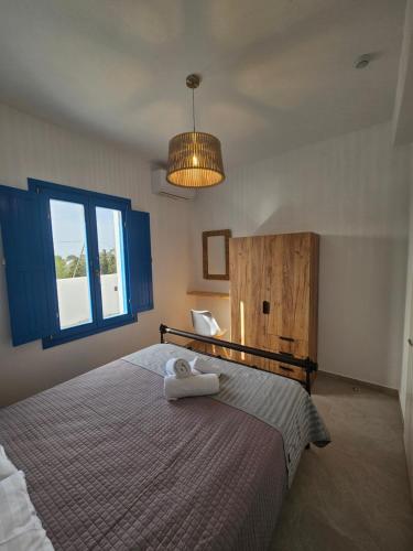 a bedroom with a bed with a towel on it at Parian Nissos Harmony Living in Angairiá