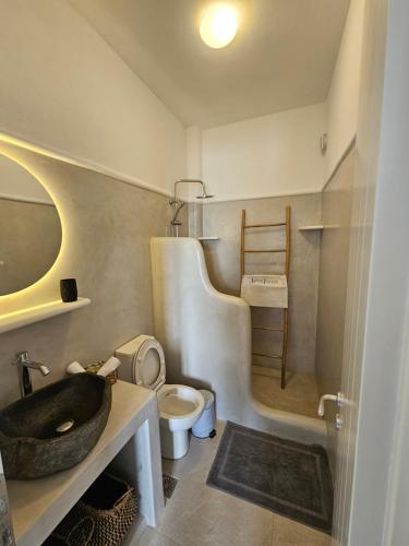 a bathroom with a sink and a toilet at Parian Nissos Harmony Living in Angairiá