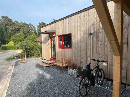 a bike parked next to a wooden house at Tiny Frida in Gifhorn