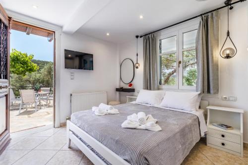 a bedroom with a bed with white towels on it at Villa Sea Horizon in Skopelos Town