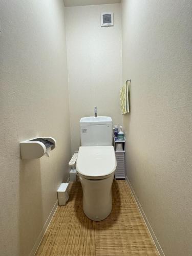 a bathroom with a white toilet in a room at Waraku No2,Guesthouse near KIX in Izumi-Sano