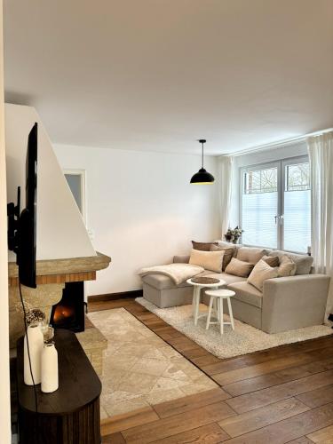 a living room with a couch and a fireplace at Ferienhaus Sandstrand in Cuxhaven