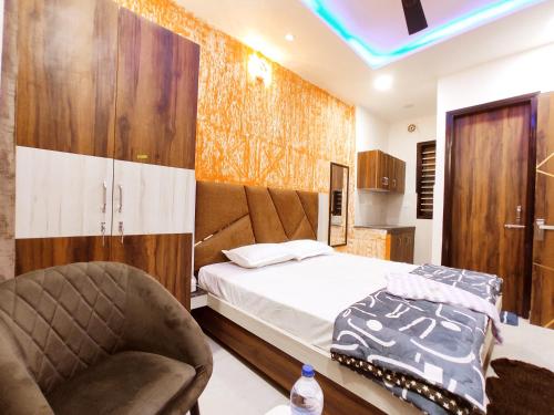 a bedroom with a bed and a chair at HOTEL THE VELVET PRIME - Premium & Luxury Suits Rooms in Phagwāra