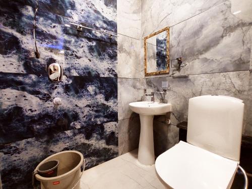 a bathroom with a toilet and a sink at HOTEL THE VELVET PRIME - Premium & Luxury Suits Rooms in Phagwāra