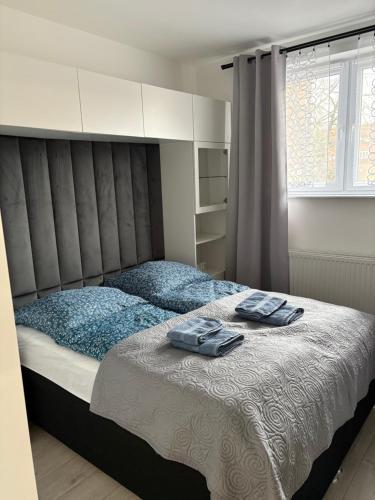 a bedroom with a bed with two towels on it at Apartament Olesno Lux in Olesno