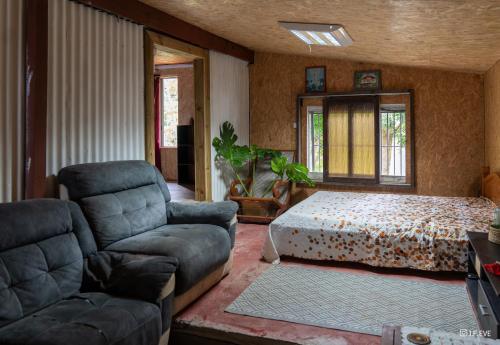 a living room with a bed and a couch at Ti kaz gogo in Salazie