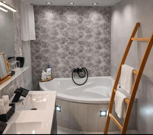 a white bathroom with a tub and a sink at Oaza Resnik in Zagreb
