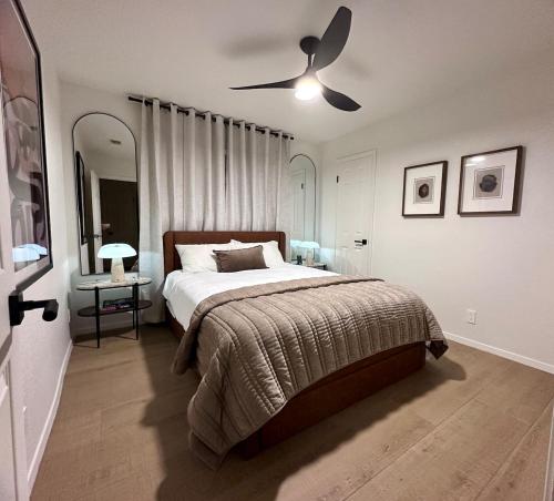 a bedroom with a bed and a ceiling fan at Midland Luxe, Pool, Fire Pit, Workspace, Pool Table in Midland