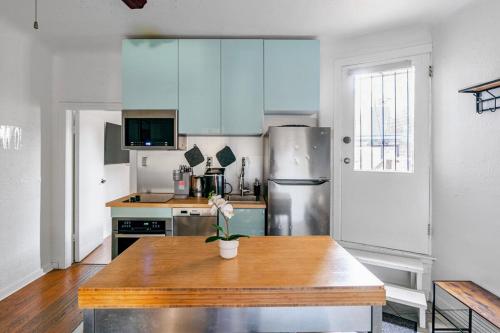 a kitchen with blue cabinets and a wooden table at Cozy 2 Bedroom 2 Bathroom with Parking in Toronto