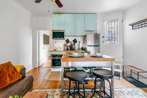 a kitchen with a table and two stools in a room at Cozy 2 Bedroom 2 Bathroom with Parking in Toronto