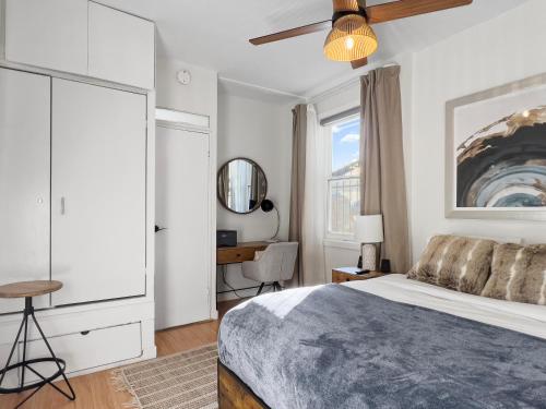 a bedroom with a bed and a desk and a window at Cozy 2 Bedroom 2 Bathroom with Parking in Toronto