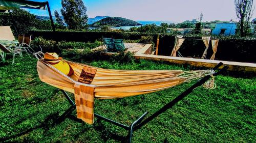 a hammock sitting on the grass in a yard at Villa Infinity View Athens Riviera in Anavyssos
