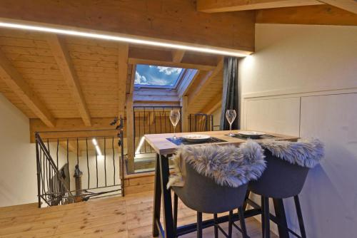 a kitchen with a table with chairs and a window at ArtiStone - "The Modern Loft" - Nature and Relax in Saint-Christophe