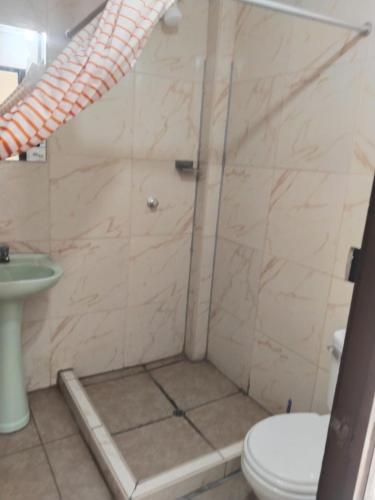 a bathroom with a shower with a toilet and a sink at Centro de Tacna quinto piso in Tacna