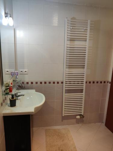 a bathroom with a sink and a shower at Tatra Frank Apartman in Štrba