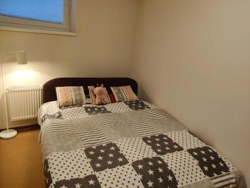 a bed with a cat sitting on top of it at Tatra Frank Apartman in Štrba