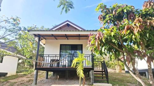 a house with a porch in front of it at TinyHouse at TigerCave in Ko Bu Bu